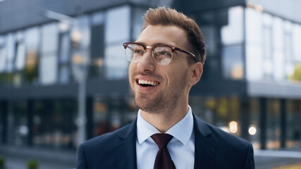 amazed businessman in glasses and suit looking away.