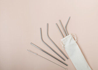 High angle view of six metal drinking straws arranged