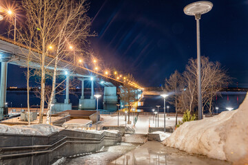 The embankment in Perm in winter, the Kama River in the evening twilight.
