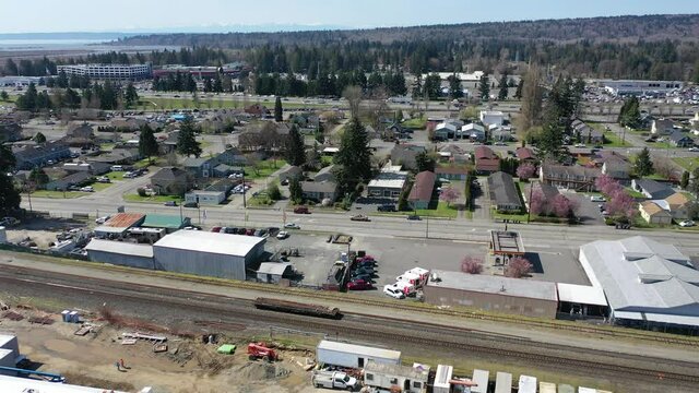 Cinematic aerial drone panning footage of downtown Marysville, by the I-5 freeway, a distant suburb, bedroom community North of Seattle on the shores of Puget Sound in Washington