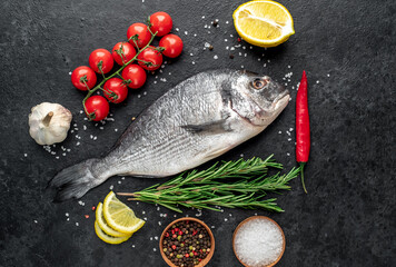 raw dorado fish on stone background