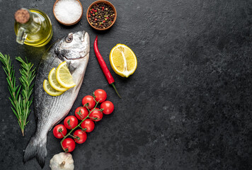 raw dorado fish on stone background with copy space for your text