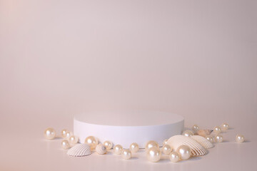 White podium on the white background with pearls and seashells. Podium for product, cosmetic...