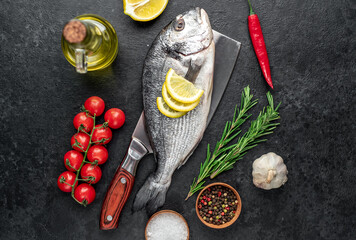 raw dorado fish on stone background