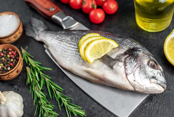 raw dorado fish on stone background