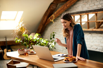 Young businesswoman having online meeting via video call while working at home.
