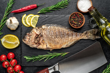 baked dorado fish on stone background