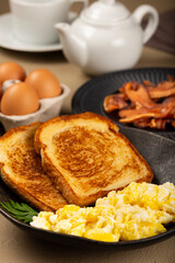 Breakfast. Scrambled egg with toast and bacon.