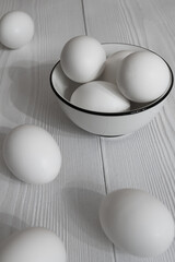 White eggs in a bowl on a wooden table - 426467764