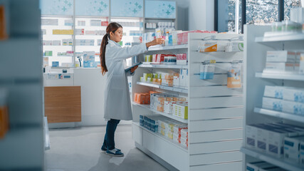 Pharmacy Drugstore: Beautiful Asian Pharmacist Uses Digital Tablet Computer, Checks Inventory of Medicine, Drugs, Vitamins, Health Care Products on a Shelf. Professional Pharmacist in Pharma Store