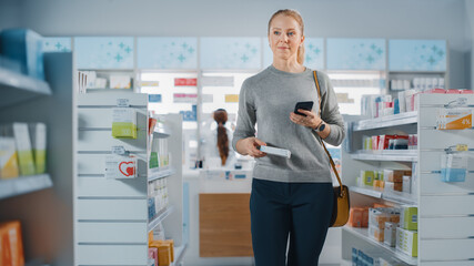 Pharmacy Drugstore: Beautiful Young Woman Decided to Buy Medicine, Drugs, Vitamins, She Foung Best Choice. Cashier at Checkout Counter Serves Customers. Shelves with Health Care Products