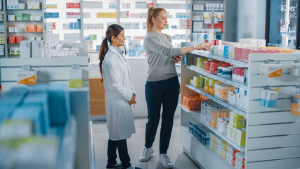 Pharmacy Drugstore: Caucasian Woman Chooses to Buy Medicine Professional Asian Pharmacist Advising,...