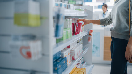 Pharmacy Drugstore: Anonymous Woman Chooses and Picks the Best Medicine Package, Supplemen Box, Drugs, Pills of the Shelf. Modern Pharma Store Health Care Products