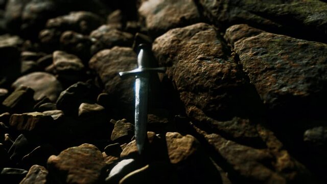 old dagger on the rock at sunset