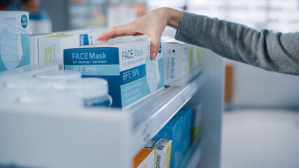 Modern Pharmacy Drugstore: Anonymous Woman Searching to Purchase Best Face Mask Package, Takes the Box. Shelves full of Health Care Products
