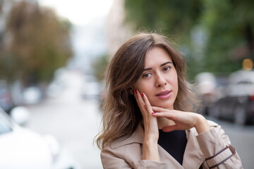 Tender brunette woman wears trench