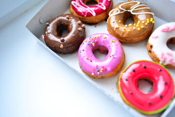 Delicious colorful donuts with different flavors and interesting decorations on the background