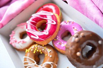 Delicious colorful donuts with different flavors and interesting decorations on the background