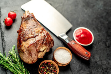 Baked turkey, turkey leg with rosemary on a stone background 