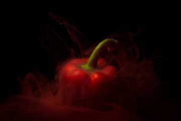 Red pepper under water with red paint smoke and liquid