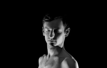 black and white photo portrait of a guy, in dramatic lighting