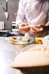 Chef in a restaurant garnish cheese plate