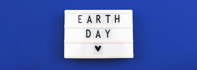 Celebration banner for Earth Day 22th april, blue background, lightbox with lettering