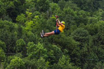 Zip line adventure, extreme rest, downhill on a rope at an angle