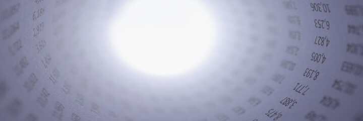 Numbers on white sheet of paper rolled into tube.