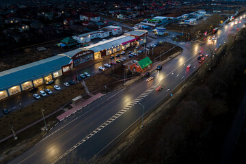 Fototapeta na wymiar The car light trails in the city street Traffic. Top Down Aerial Drone view of a road at night