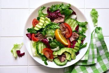 Tuna salad with fresh vegetables . Top view with copy space.