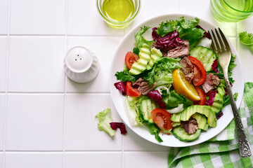 Tuna salad with fresh vegetables . Top view with copy space.