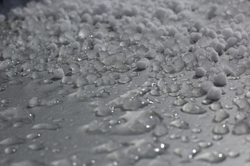 Closeup of melting graupel on a windowsill.