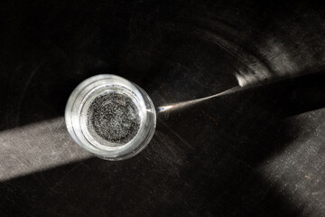 ttransparent glass on a black background in the sunlight gives beautiful rays and glare in the...