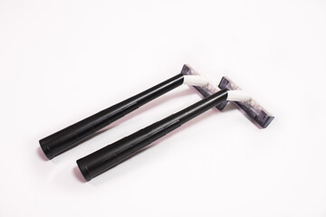 Two black disposable razors isolated on white background
