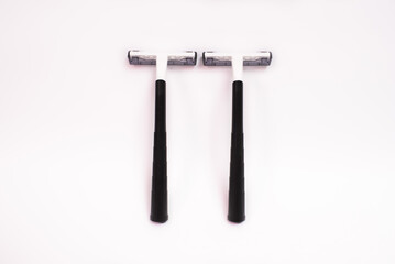 Two black disposable razors isolated on white background