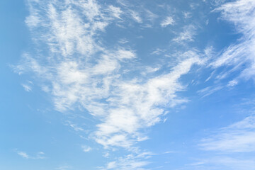 White cirrus clouds against the blue sky. Clouds background