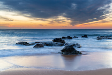 Sunrise at the beach with high cloud
