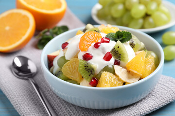 Delicious fruit salad with yogurt on table