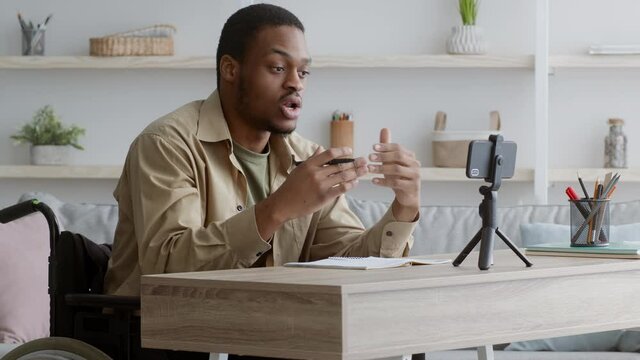 Handicapped African American Blogger Guy Making Video On Smartphone Indoor