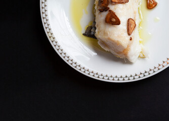 Hake head fillet baked with garlic. Homemade food concept. Copy space.