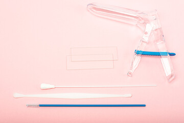 Disposable gynecological examination kit on a pink background. Gynecological examination set. The view from the top.