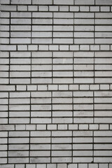 Background from the wall laid out of a lossed white brick connected cement