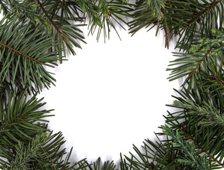 Natural frame of pine needles. In the middle is a white surface on which a message can be written.