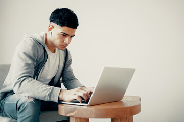 A talented freelance designer works at home on a laptop in a program for layout layouts. Copy...