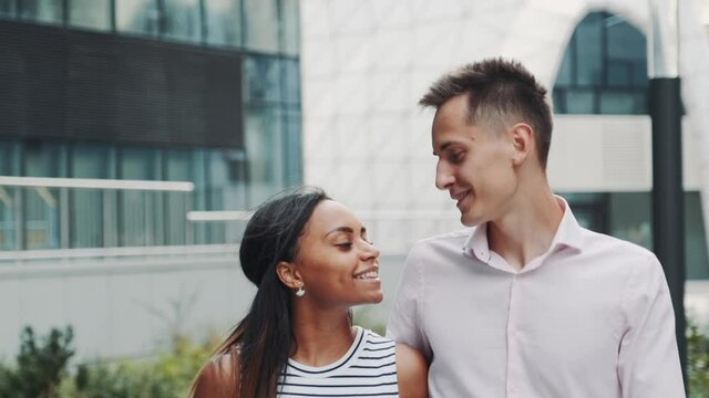 Close-up of cheerful multiracial couple in love kissing each other on date