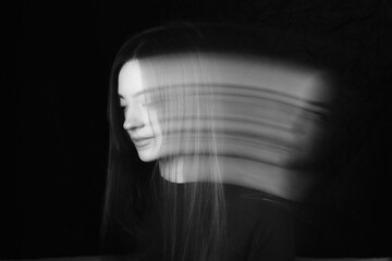 Blurred female portrait in the dark.