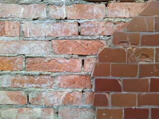 red brick wall and half ruined brown tiles