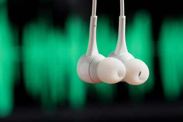 Fototapeta na wymiar headphone hanging with sound waves on blurred background