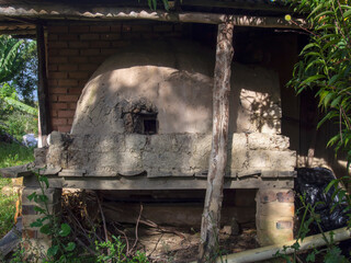 Fototapeta na wymiar A traditional rustic homemade bricks oven, attached to an old rural house in a farm near the town of Arcabuco, in the central Andean mountains of Colombia.